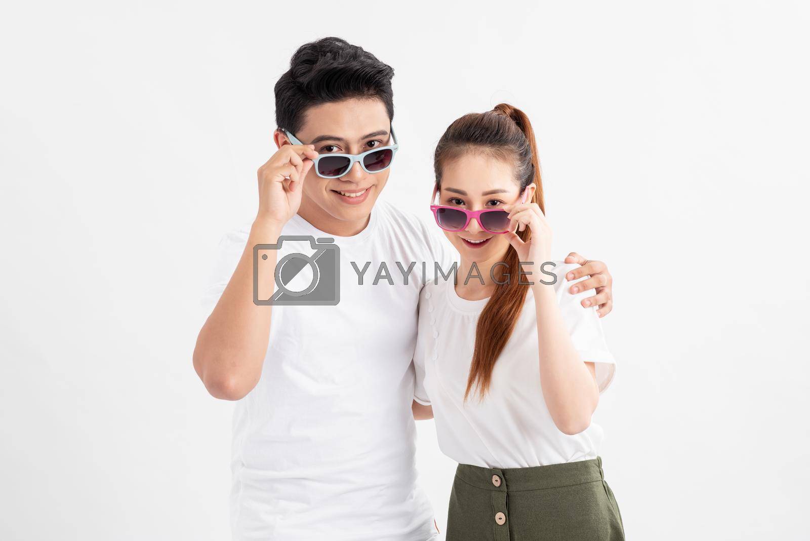 Royalty free image of Funny couple in casual style clothes and color glasses looking at camera. by makidotvn