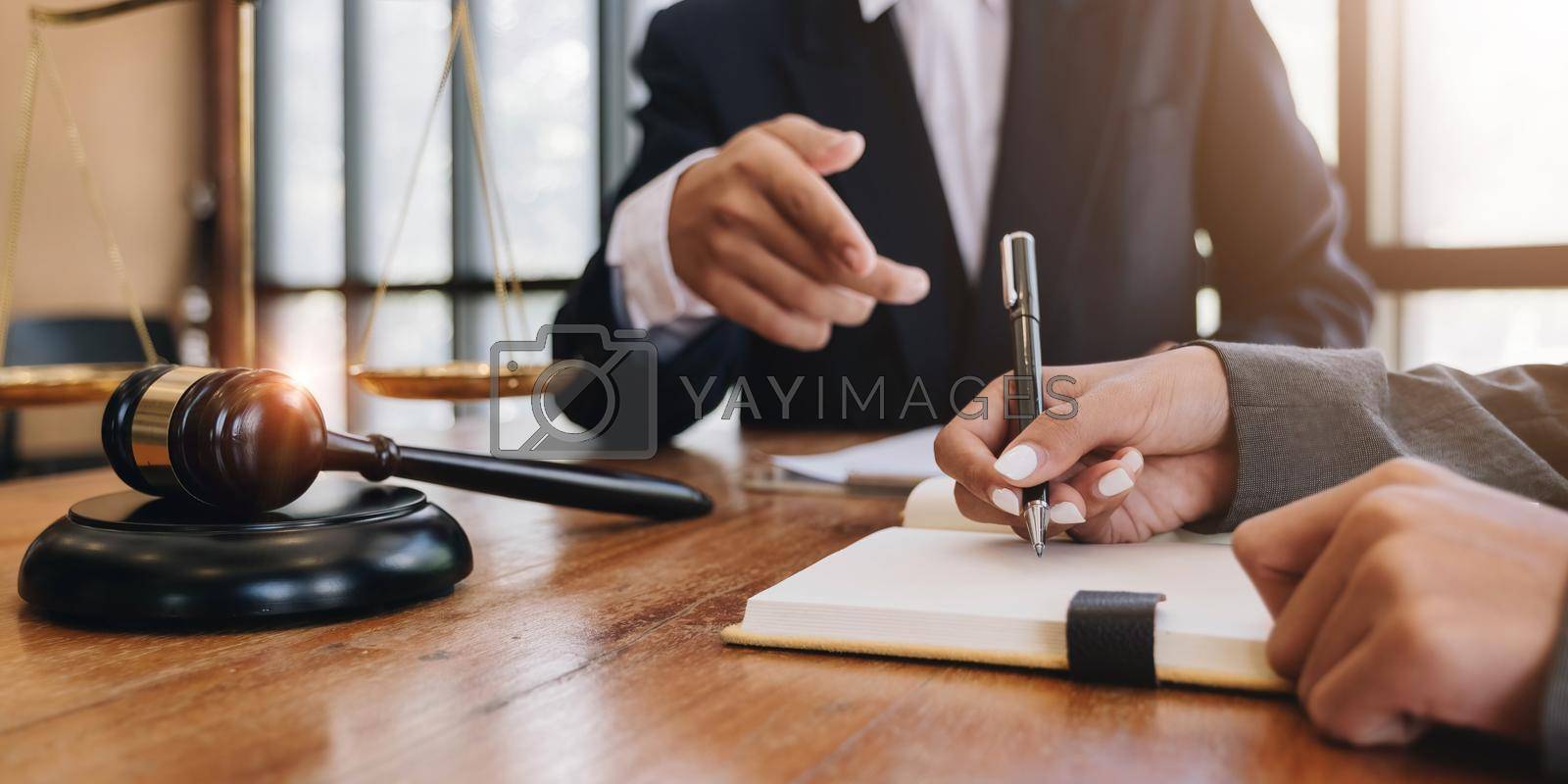 Royalty free image of Consultation of Businessman or lawyer team meeting with client, Law and Legal services concept, Good service cooperation, Hands using tablet and laptop. by wichayada