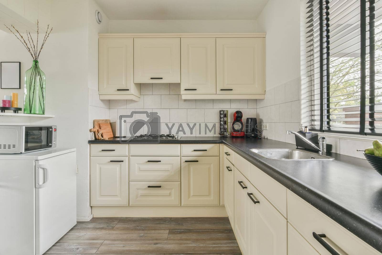 Royalty free image of Small kitchen interior in modern apartment by casamedia