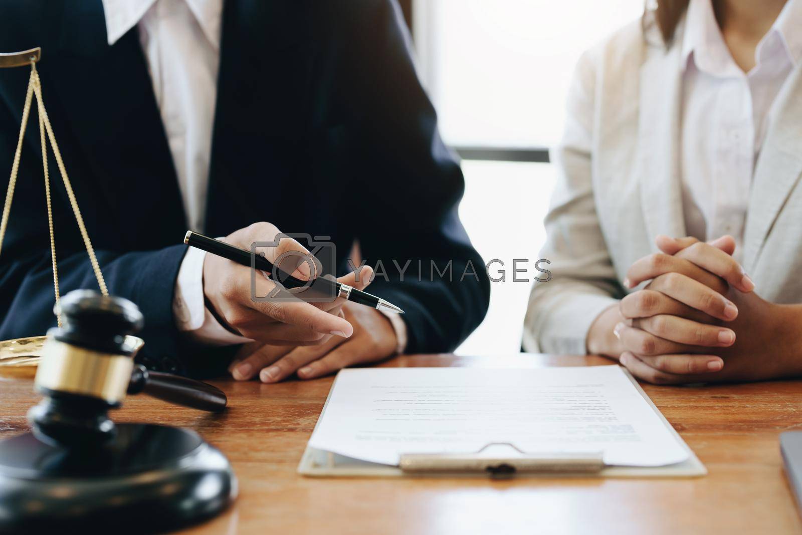 Royalty free image of The client is consulting with a lawyer on legal matters by Manastrong