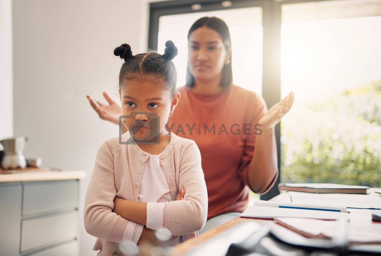Royalty free image of Upset, discipline and family while offended and stubborn little girl looking unhappy with her scolding mother in the background. Naughty, problem and bad child angry and ignoring her parent at home by YuriArcurs