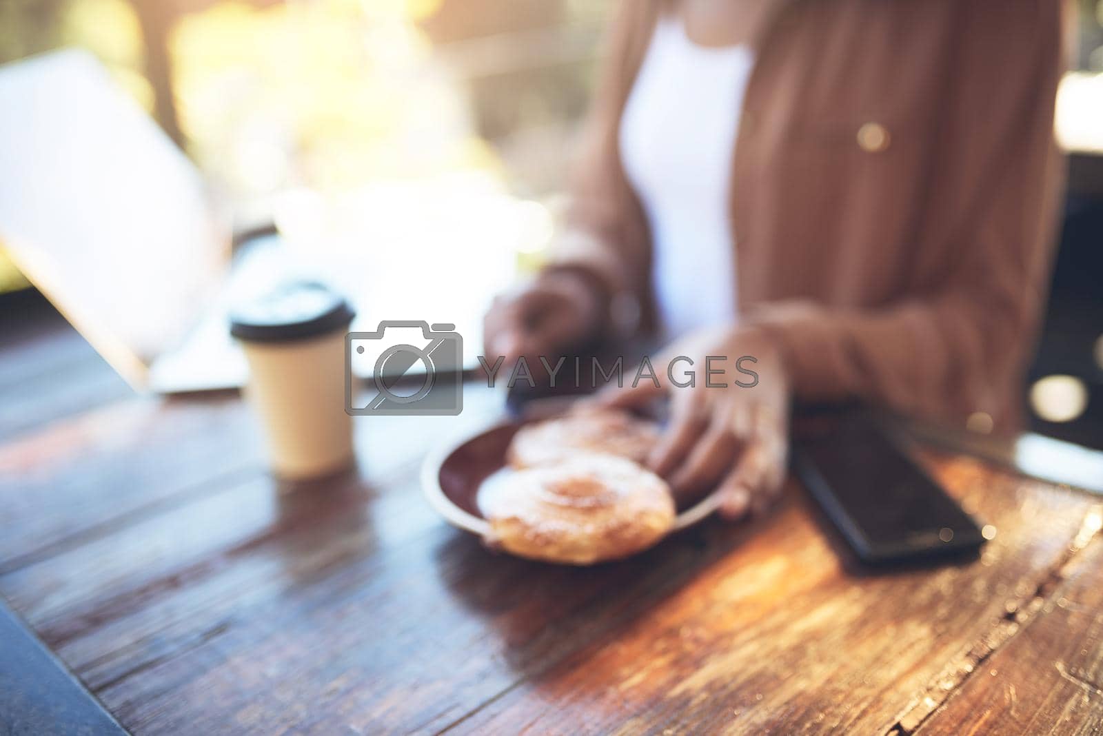 Royalty free image of Dont let hunger make you blurry. a customer sitting in a coffee shop. by YuriArcurs