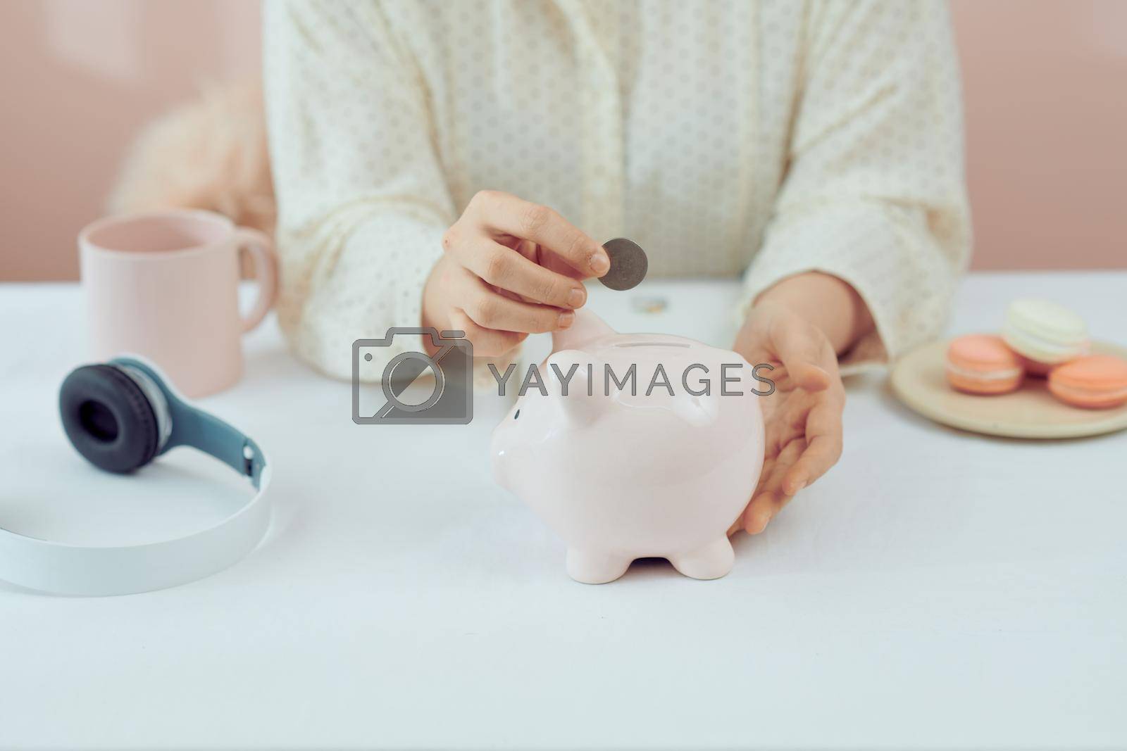 Royalty free image of plan finance and savings money.young women put money coin in piggybank and calculate cost. by makidotvn