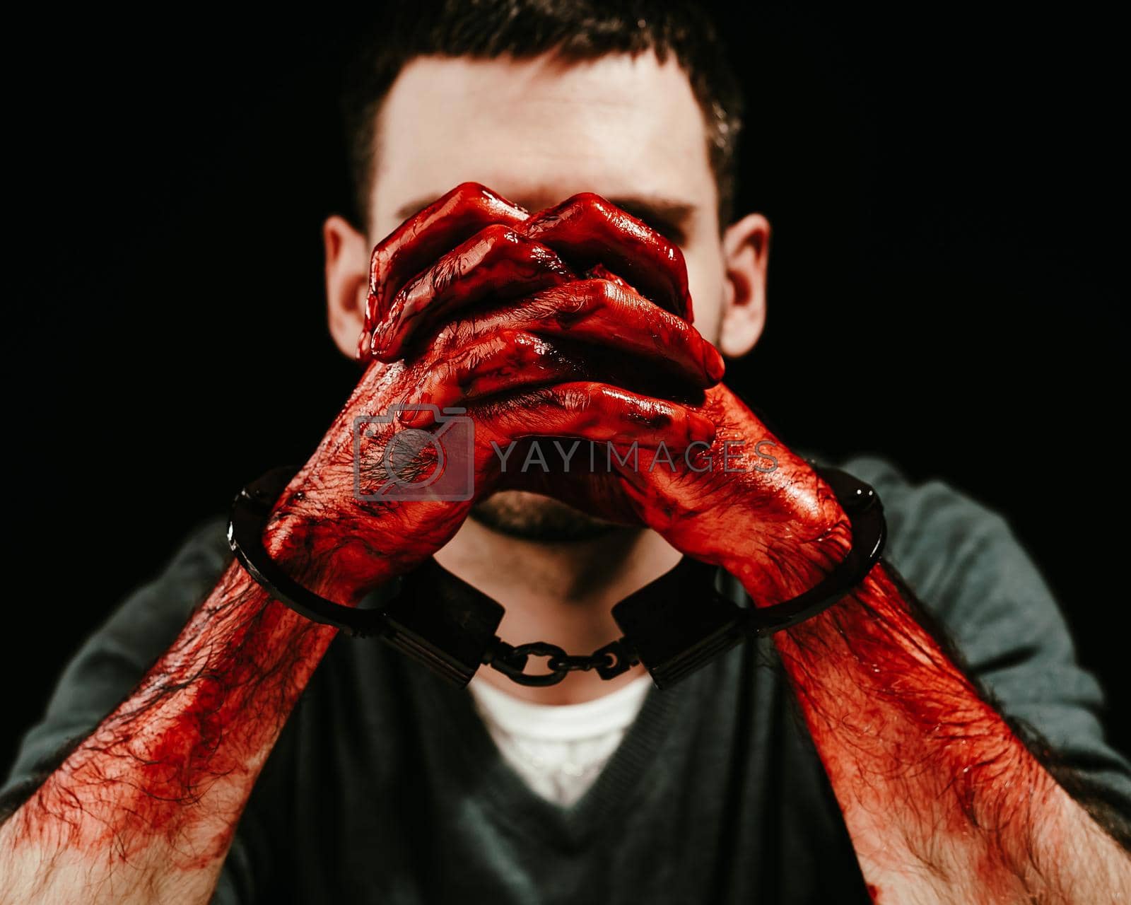 Royalty free image of Portrait of a man with bloody hands handcuffed. by mrwed54