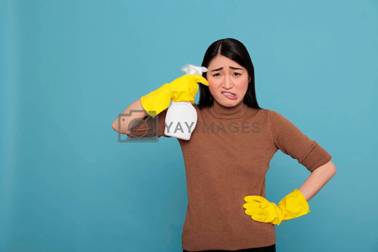 Royalty free image of Asian tired stressed and frustrated asian houseworker from daily chores by DCStudio