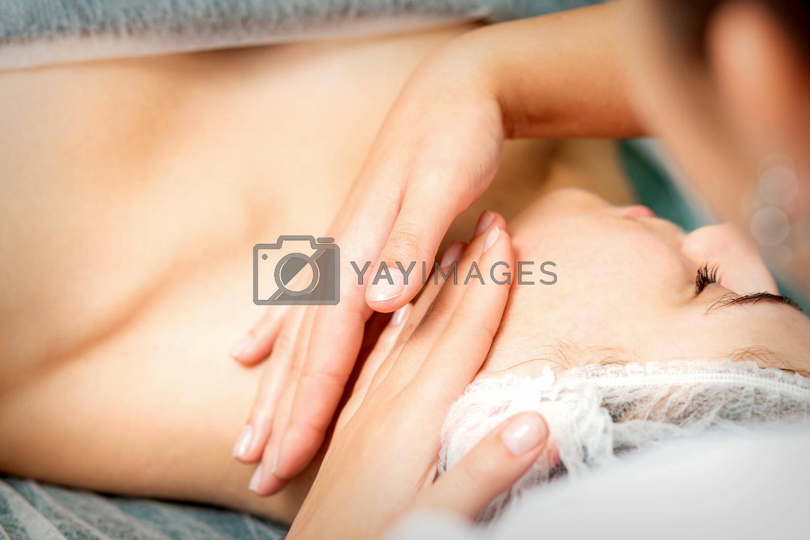 Royalty free image of Young woman receiving facial massage by okskukuruza