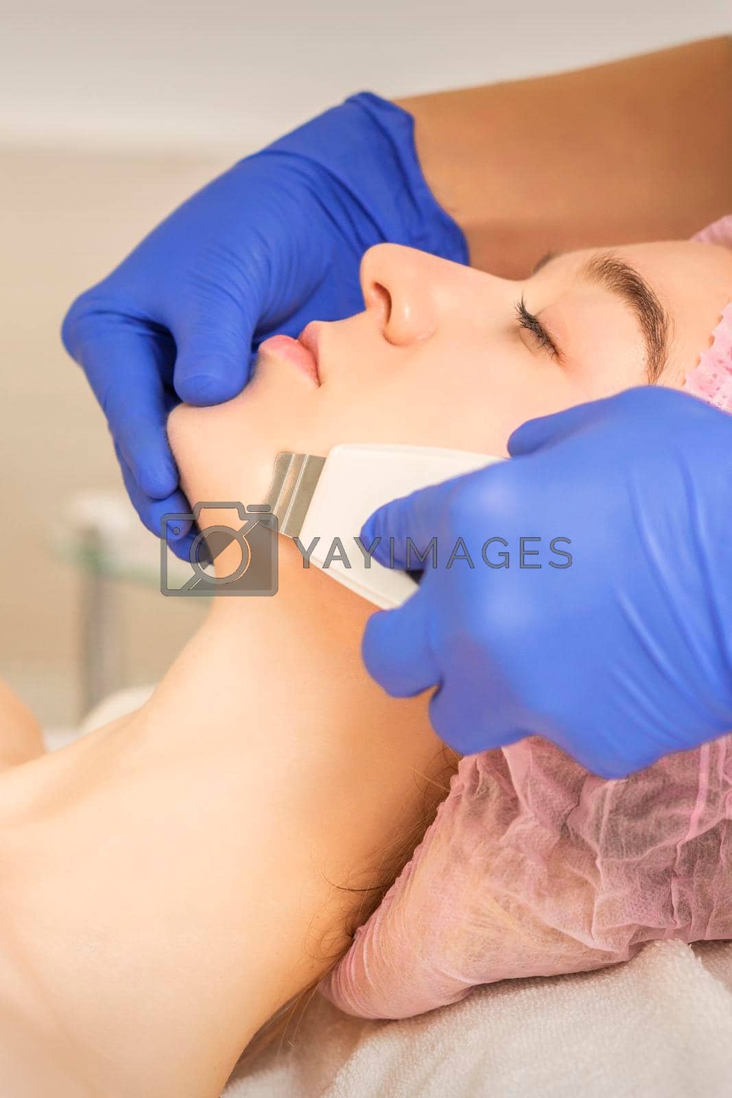 Royalty free image of Woman receiving ultrasonic facial cleansing by okskukuruza