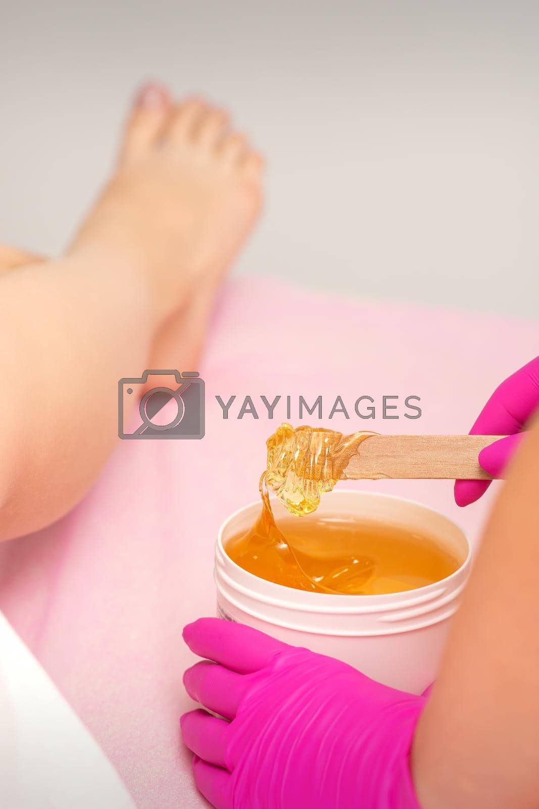 Royalty free image of Cosmetologists waxing the female legs by okskukuruza