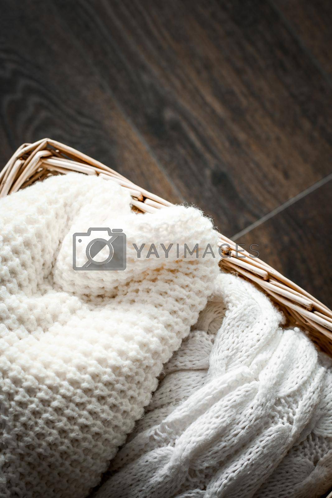 Royalty free image of Knitted winter clothes in a basket by Anneleven