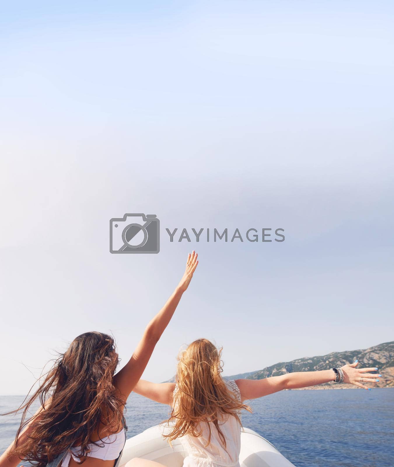 Beautiful girl friends arms raised travel on speed boat to paradise island for relaxing nature tourist destination vacation discover explore.