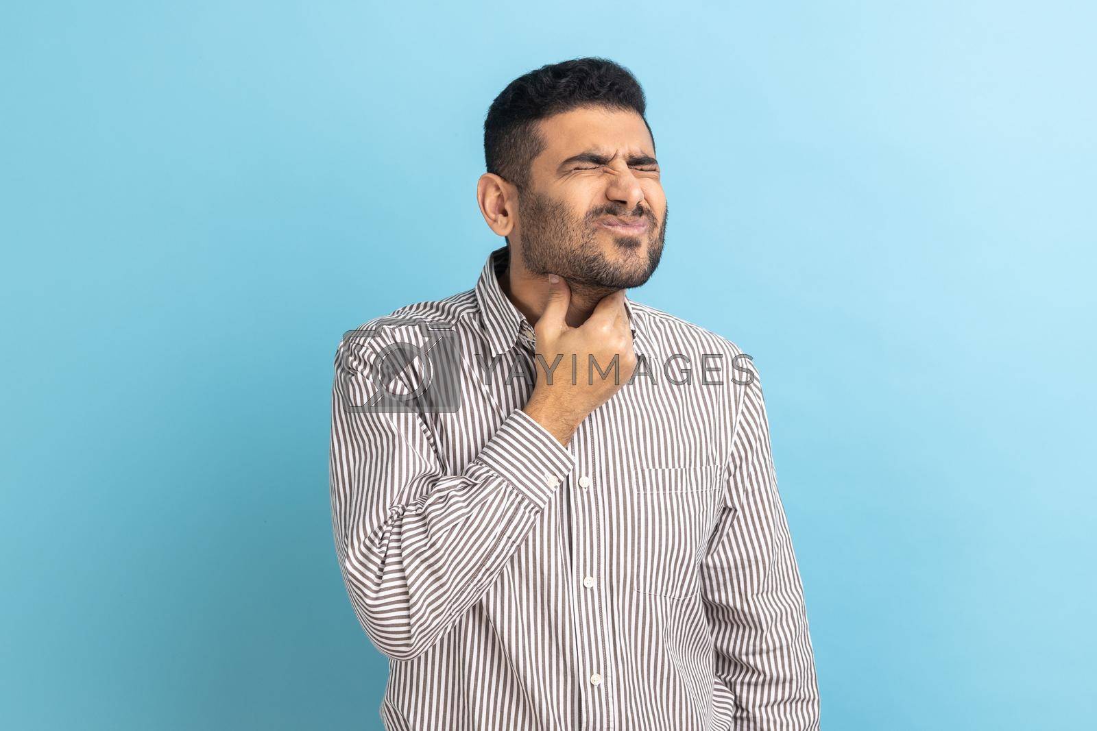 Royalty free image of Unhappy ill businessman touching her neck, suffering sore throat, viral infection or flu symptoms. by Khosro1