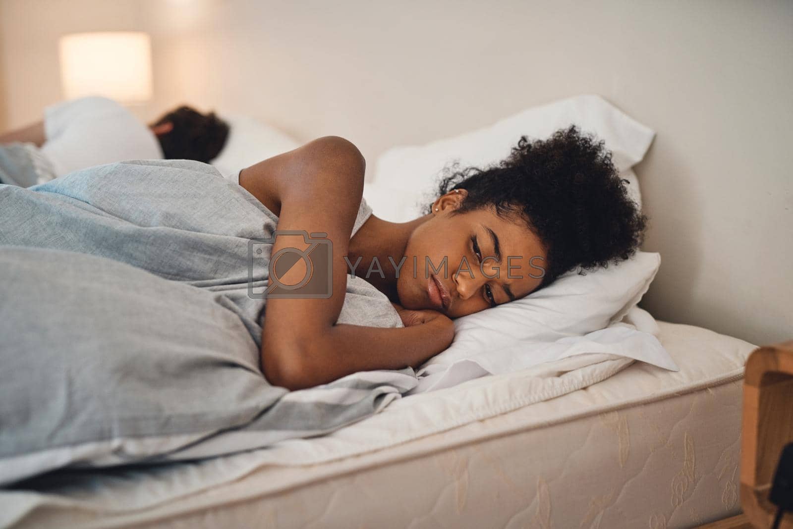 Royalty free image of Sad, bad sleep and insomnia of a woman having relationship issues at home. Upset female or couple in the bedroom after having an argument. Depressed lady in thought and conflict with her husband. by YuriArcurs