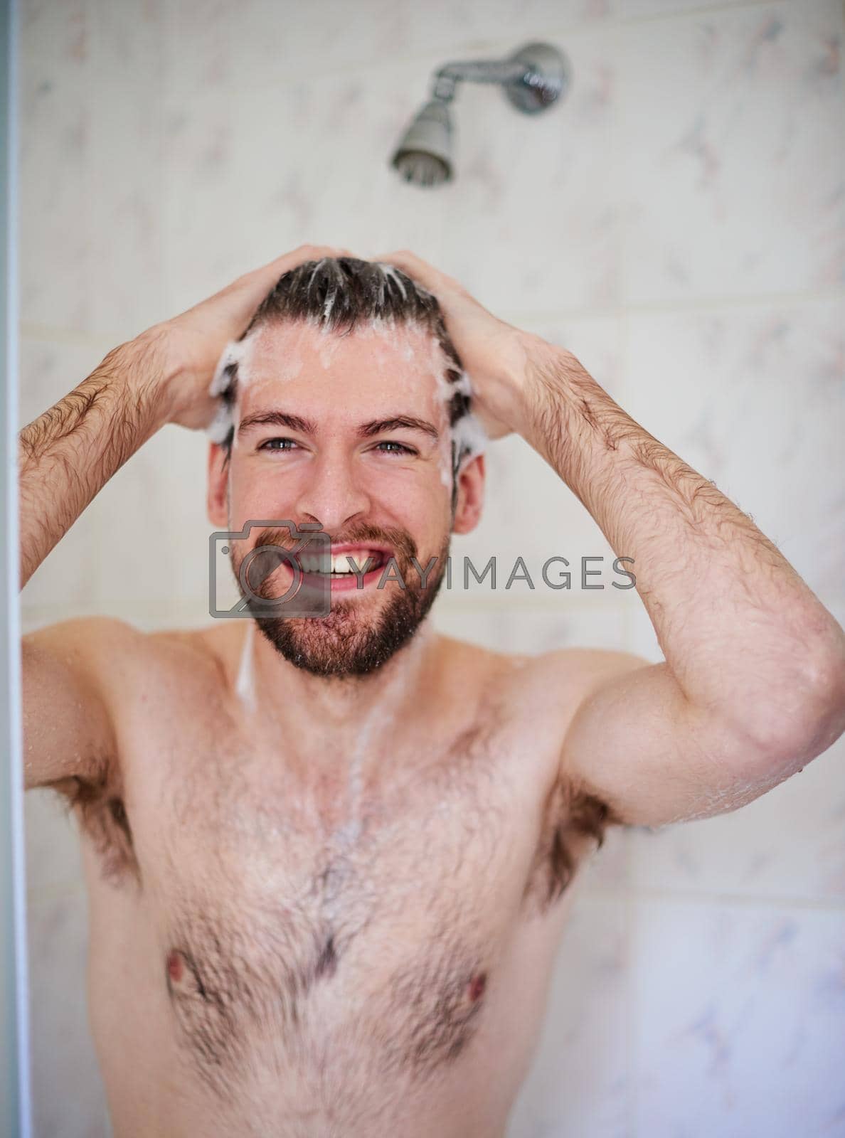 Royalty free image of His daily grooming routine. a handsome young man having a shower at home. by YuriArcurs