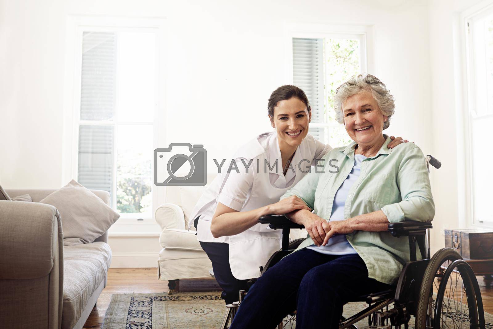 Royalty free image of Support with a smile. Portrait of a smiling caregiver and a senior woman in a wheelchair at home. by YuriArcurs