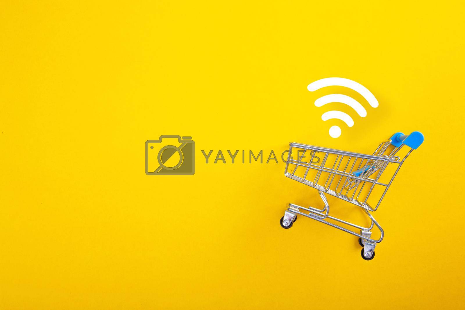 Royalty free image of close-up of shopping trolley with wifi signal on yellow background by tehcheesiong