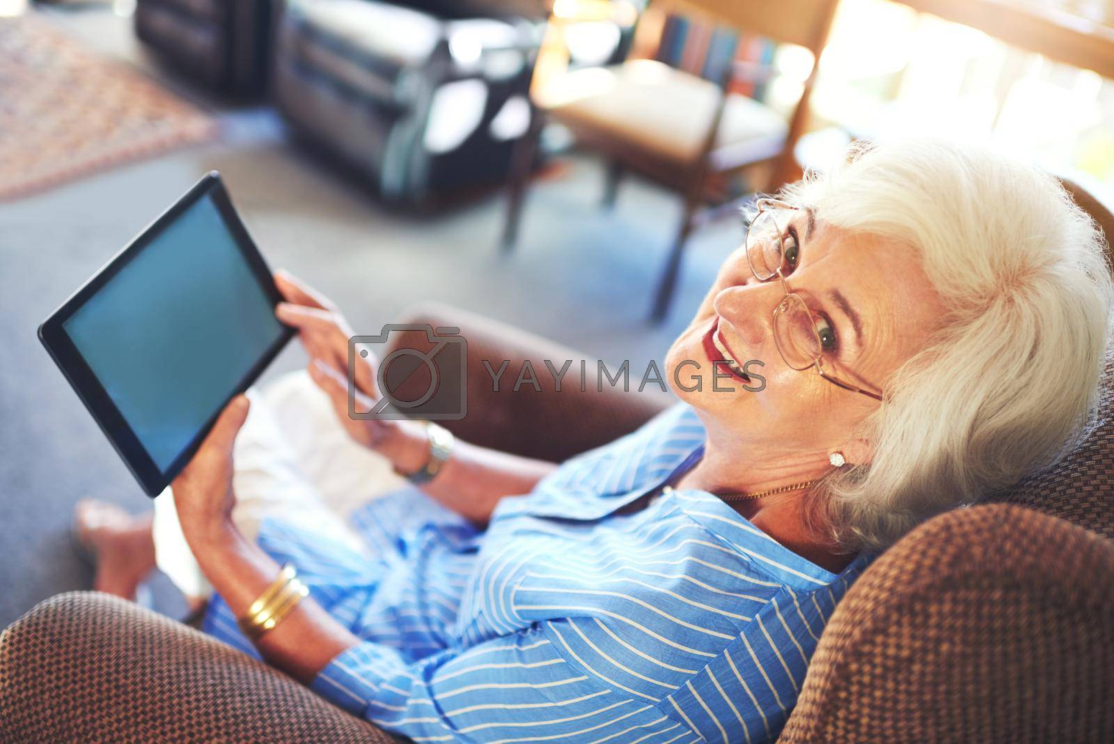 Technology is for anyone at any age. a senior woman using a tablet at home