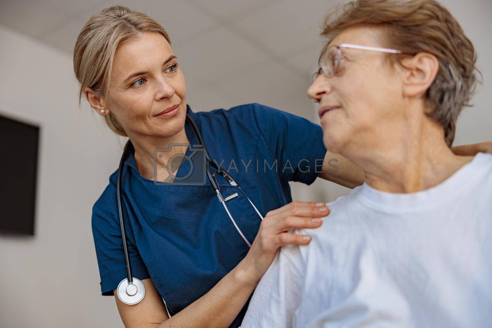 Royalty free image of Doctor supporting a sick patient before medical procedures in a hospital room by Yaroslav_astakhov