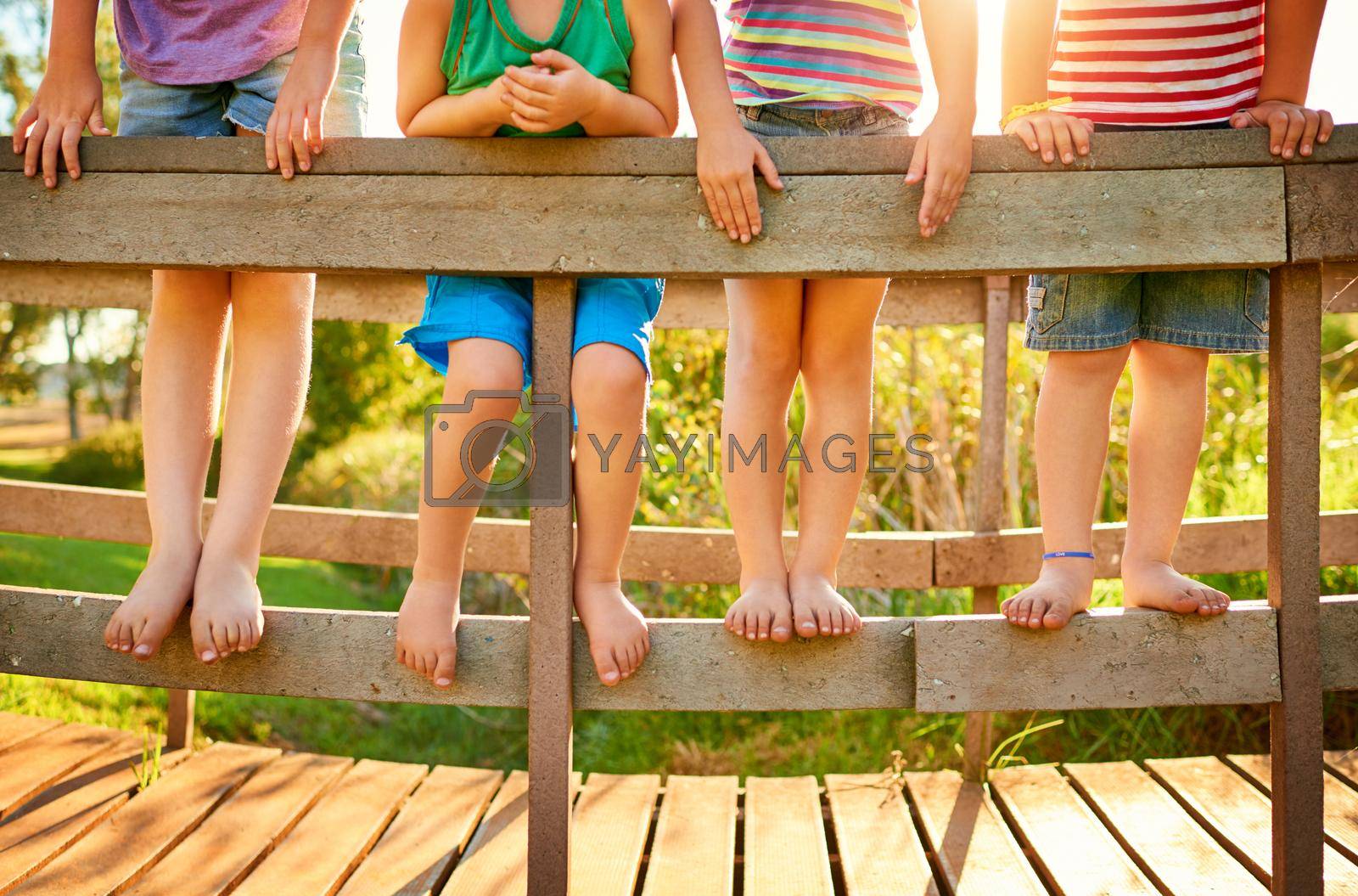 Royalty free image of These feet are ready to jump into a day of fun. little kids playing outdoors. by YuriArcurs
