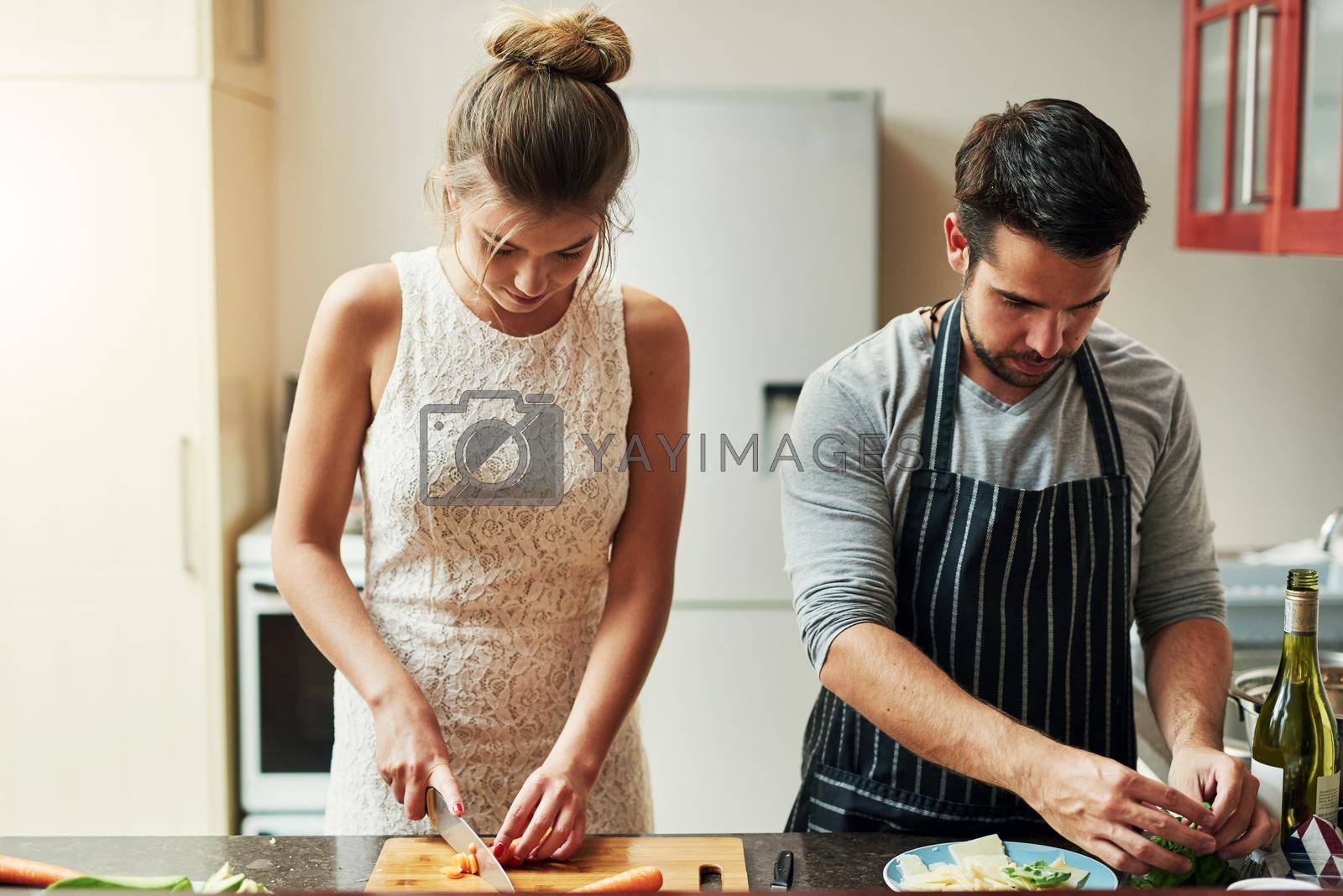 Cooking with love provides food for the soul. an affectionate young couple preparing food together at home