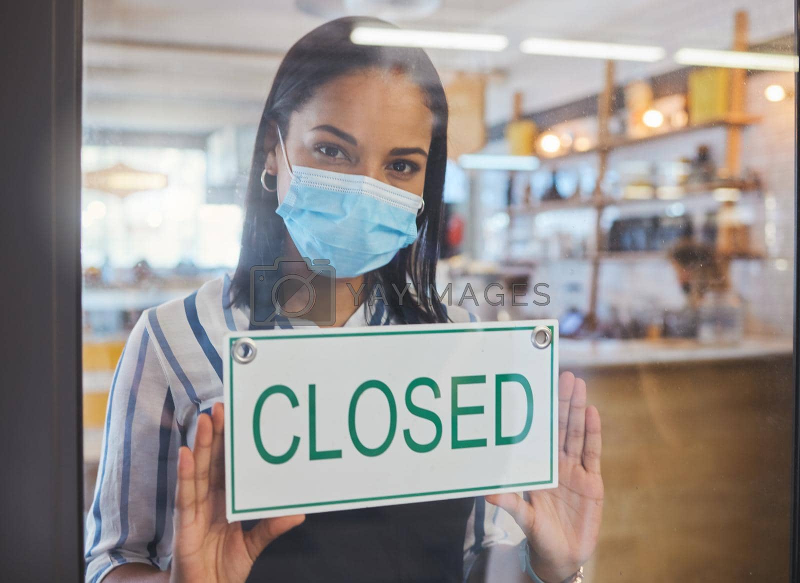Royalty free image of Compliance, safety and economic crisis closing store due to covid19 pandemic, sad and in debt. Small business owner frustrated about fail startup, hanging a sign on the window or entrance of shop by YuriArcurs