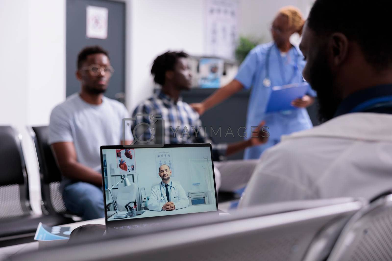 Royalty free image of Medic talking on videocall with physician by DCStudio