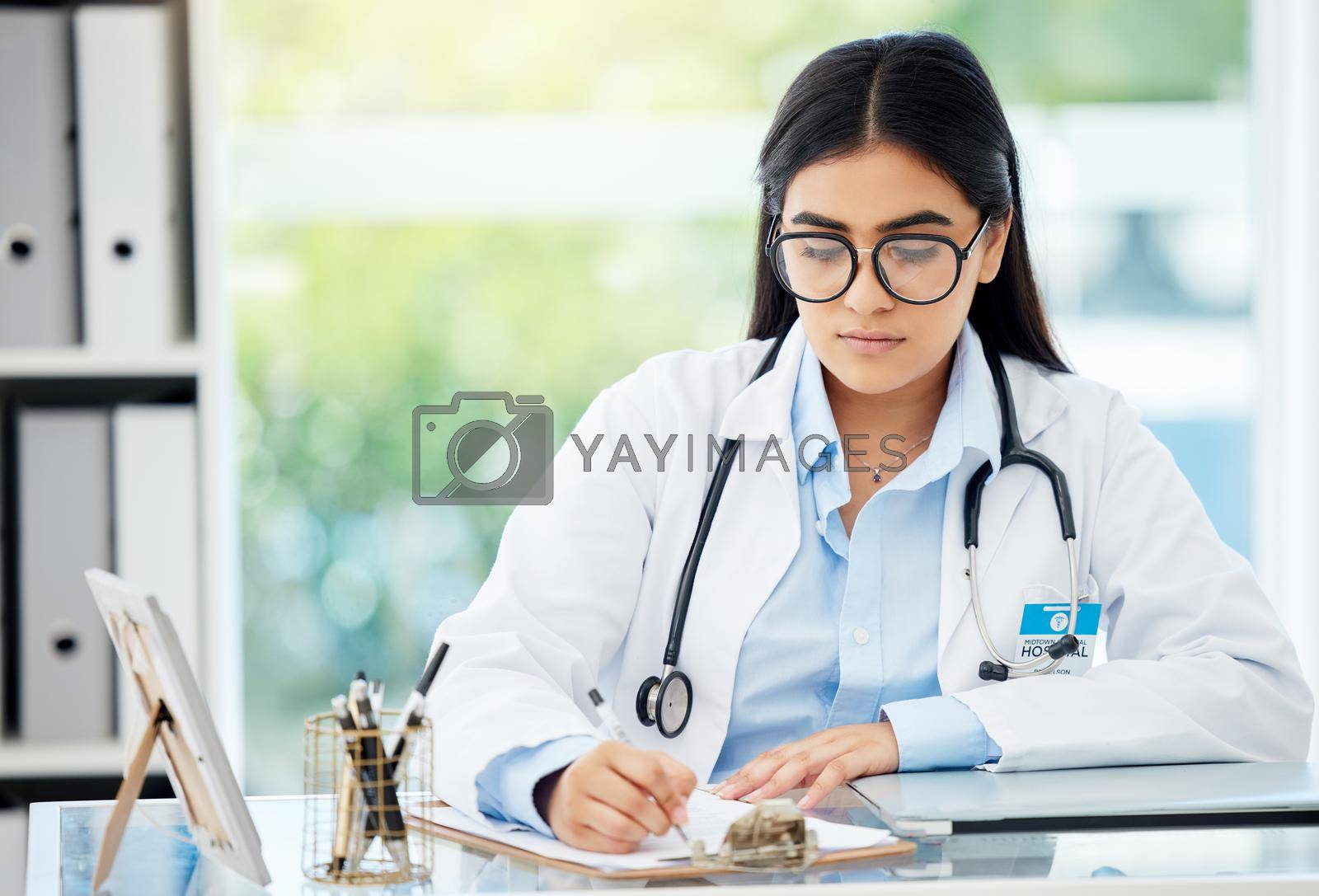 Doctor, insurance and medical of a woman filling out patient history for diagnosis at the hospital. Healthcare worker or nurse writing on paper with clipboard for health and wellness at the office