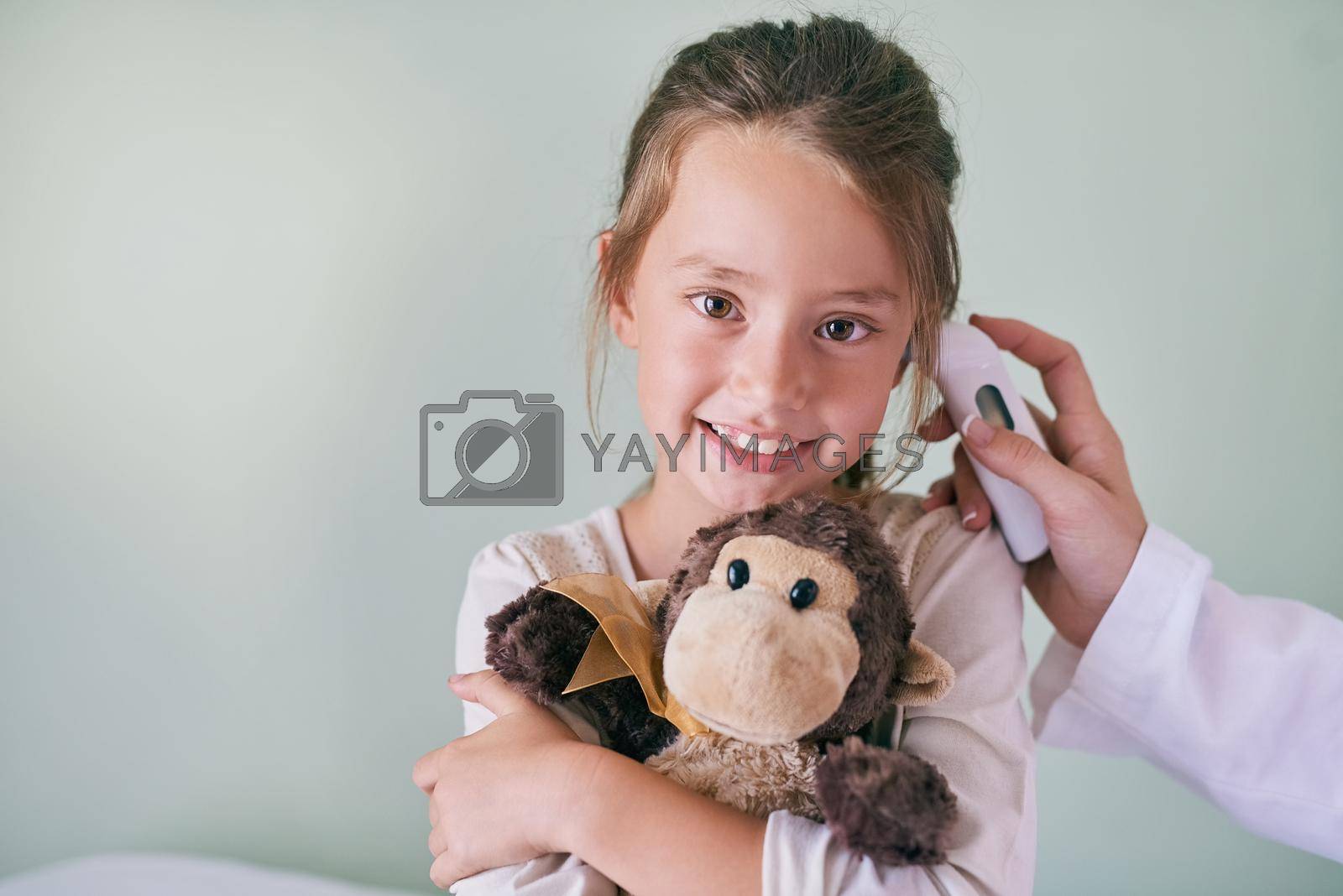 Royalty free image of Monkey is always encouraging me to be brave. a little girl having her ears examined by her pediatrician. by YuriArcurs