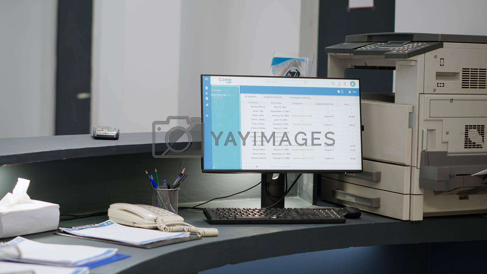 Royalty free image of Hospital reception counter with computer desktop by DCStudio