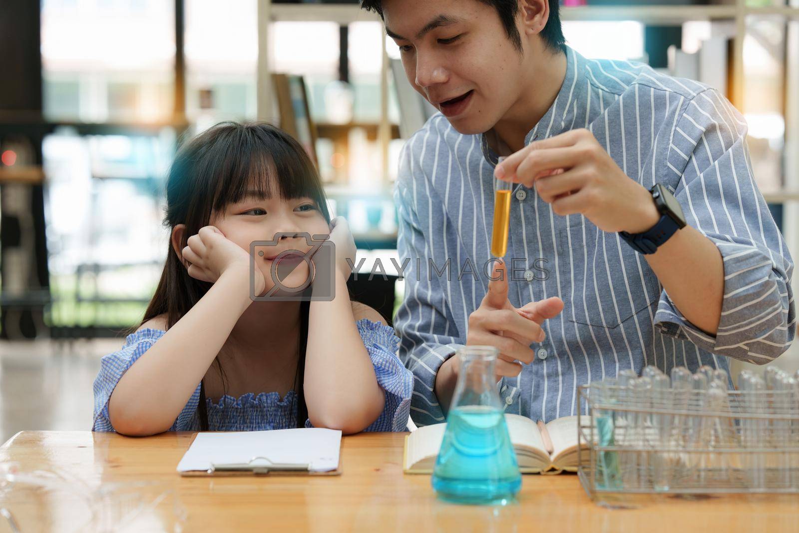Royalty free image of Kid and father doing science experiments. Education science concept by itchaznong