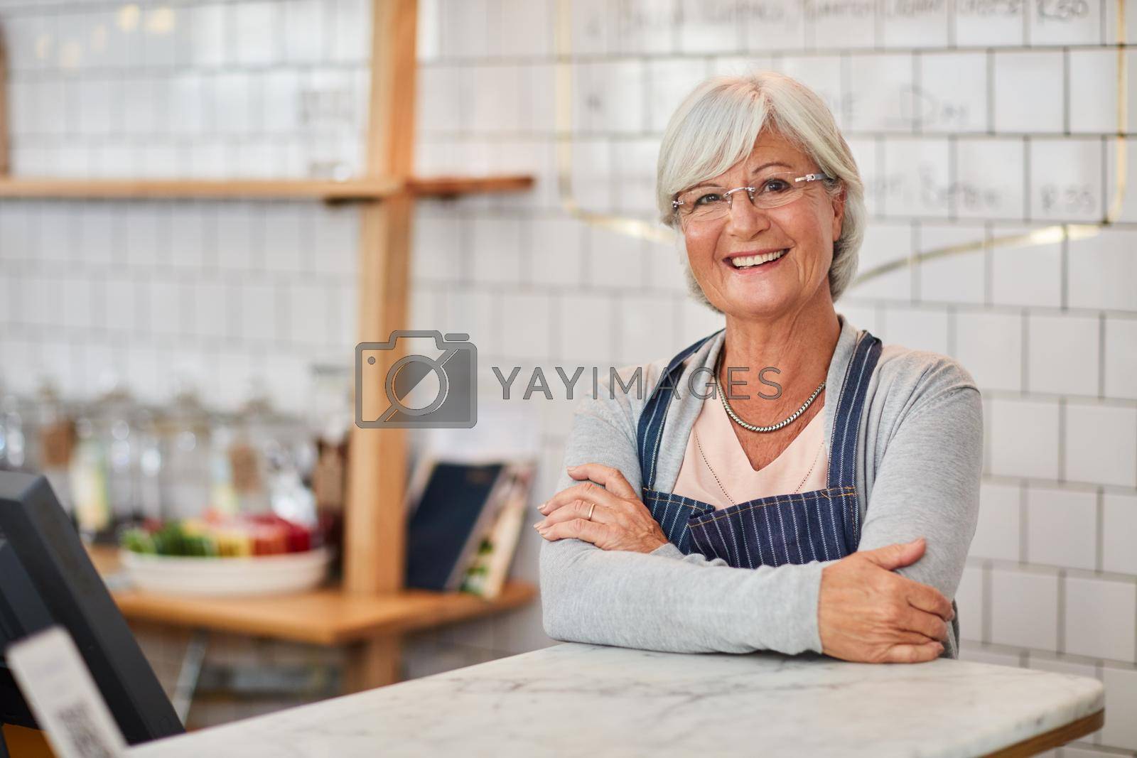 Royalty free image of My coffee shop is my happy place. Portrait of a happy senior business owner posing at the counter in her coffee shop. by YuriArcurs