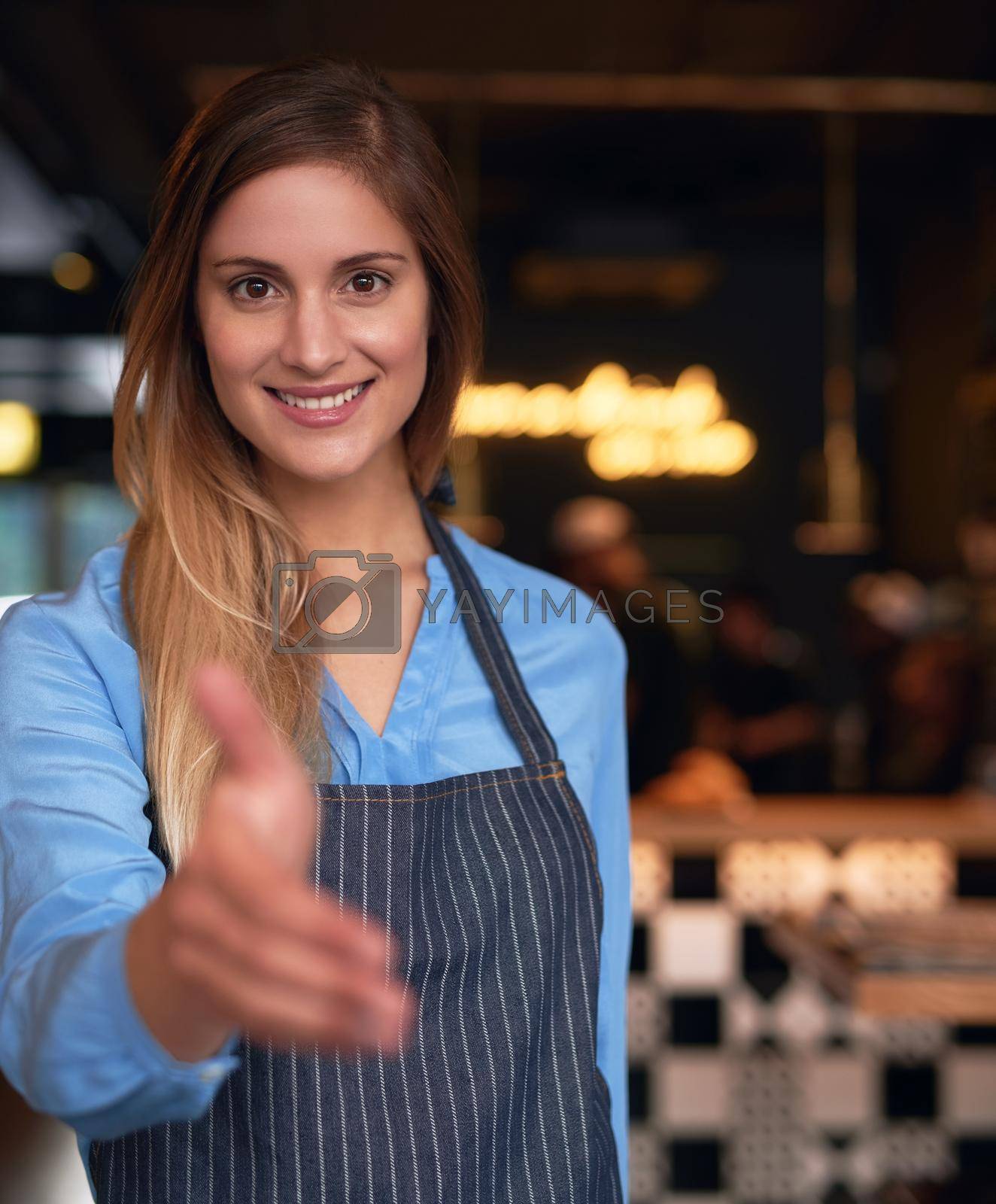 Royalty free image of Welcome to my coffee shop. Cropped portrait of an attractive young woman welcoming you into her coffee shop. by YuriArcurs