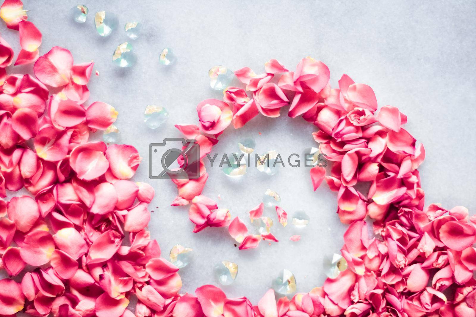 Royalty free image of Rose petals on marble stone, floral background by Anneleven