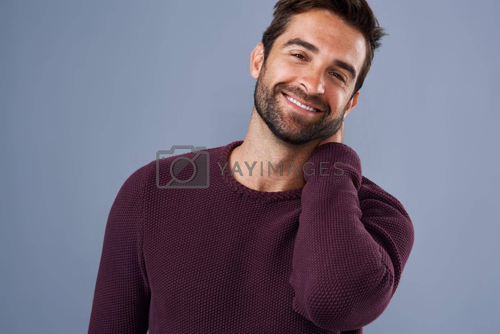 Royalty free image of Happy and handsome. Whats not to love. Studio shot of a handsome and happy young man posing against a gray background. by YuriArcurs