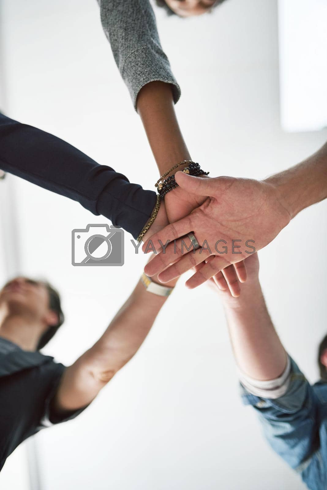 Royalty free image of Keeping their unity alive. a group of people stacking their hands on top of each other. by YuriArcurs