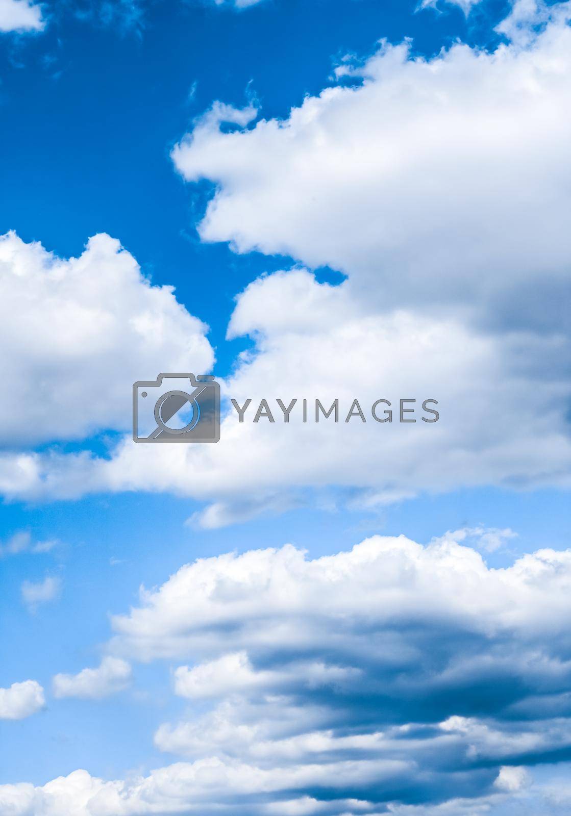 Royalty free image of Blue sky background, white clouds and bright sunlight by Anneleven