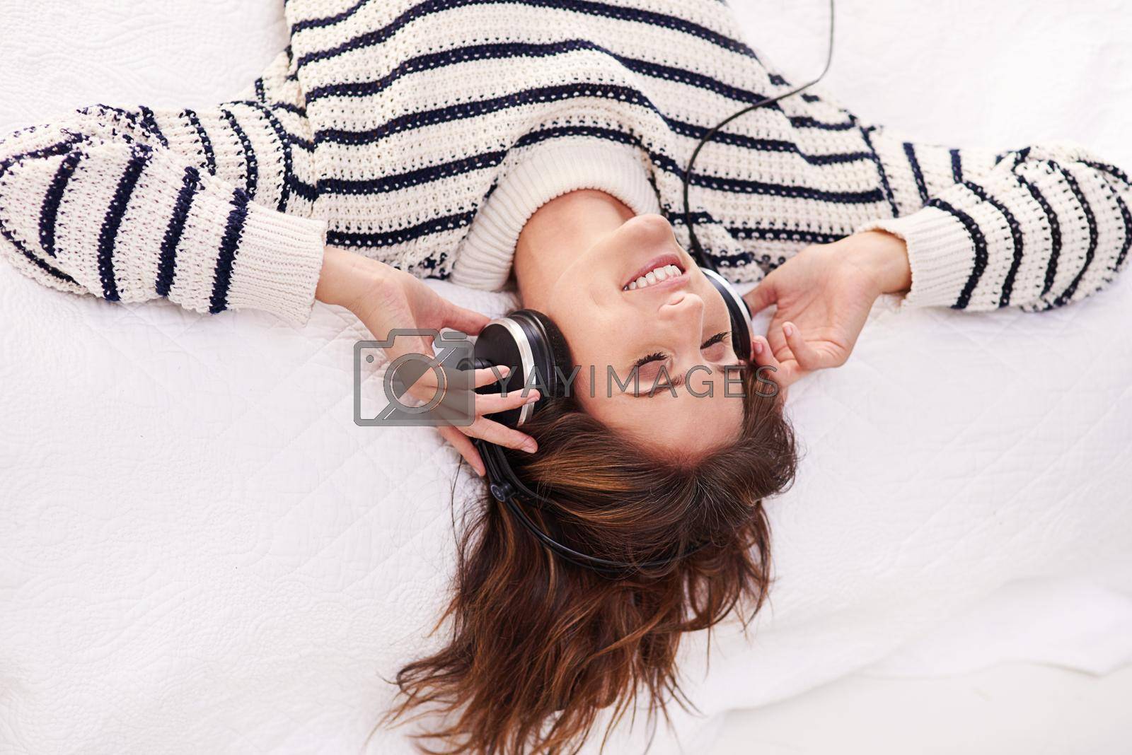Royalty free image of Music is her escape. a beautiful young woman listening to music at home. by YuriArcurs
