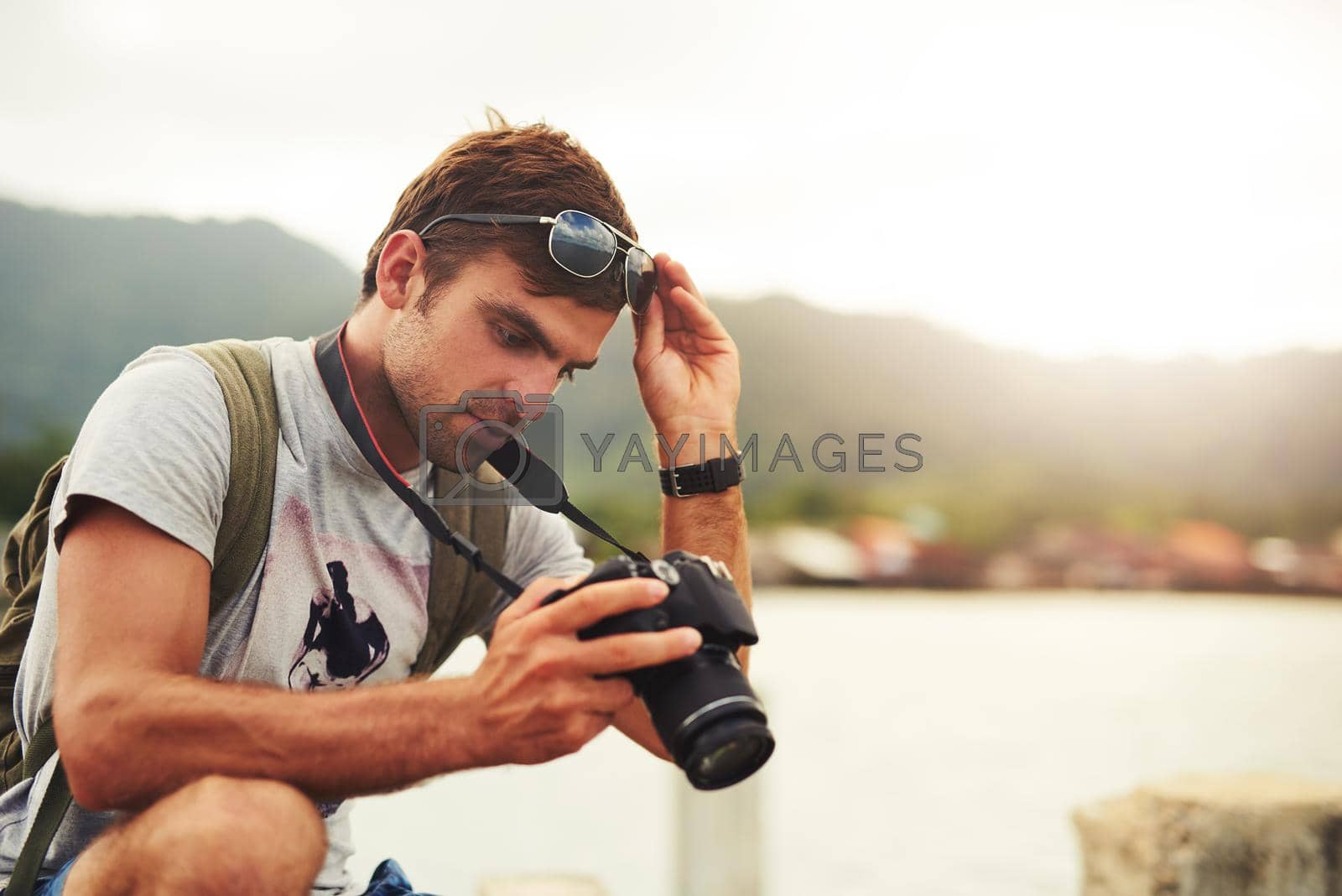 Royalty free image of Make that moment last forever. a young man out with his camera. by YuriArcurs