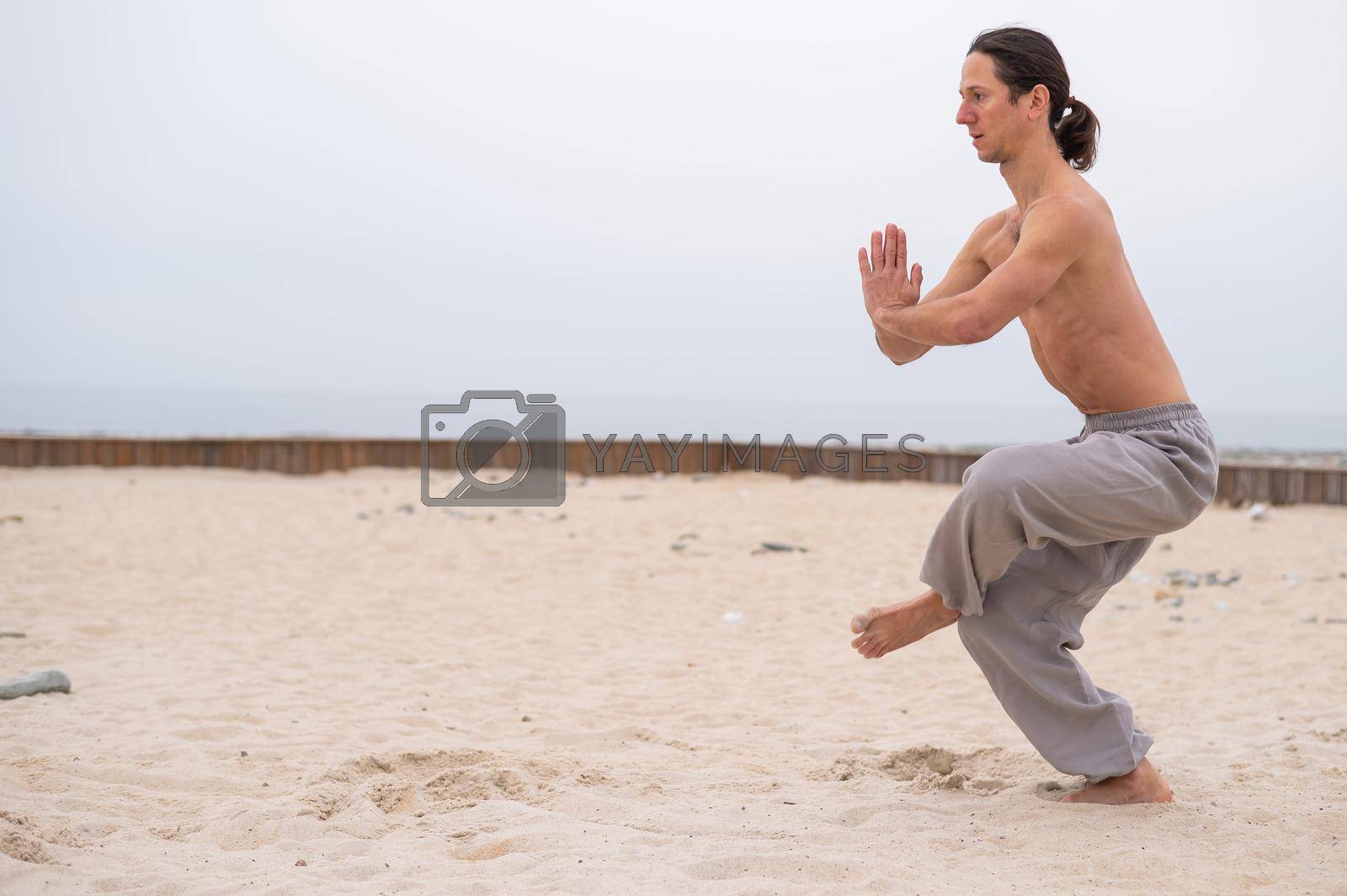 Royalty free image of Caucasian man practices martial arts outdoors. balance and meditation. by mrwed54