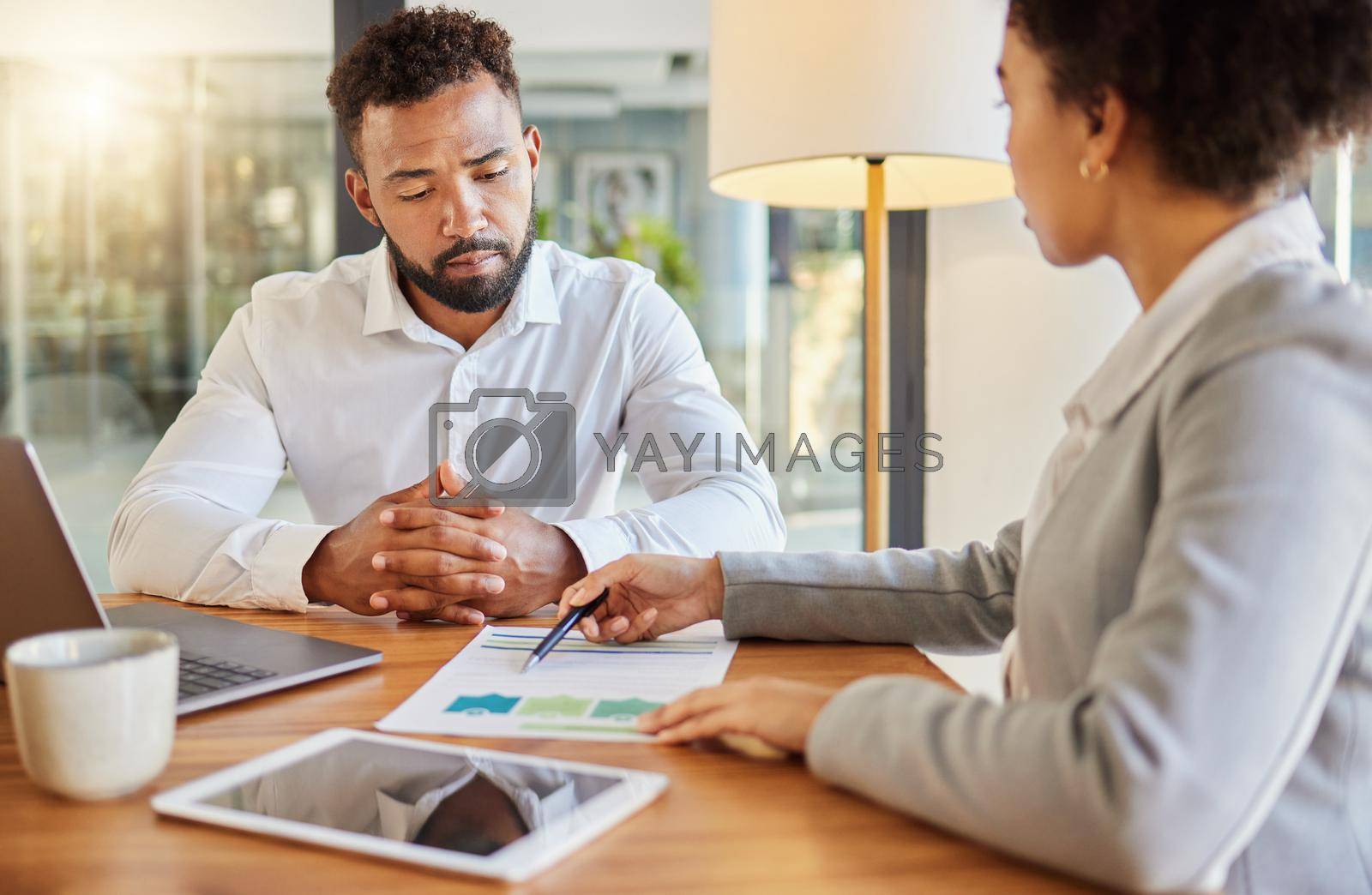 Royalty free image of Accountant consulting an entrepreneur about company financial performance in an office using statistics. Finance advisor in a meeting having a business growth strategy discussion with businessman by YuriArcurs