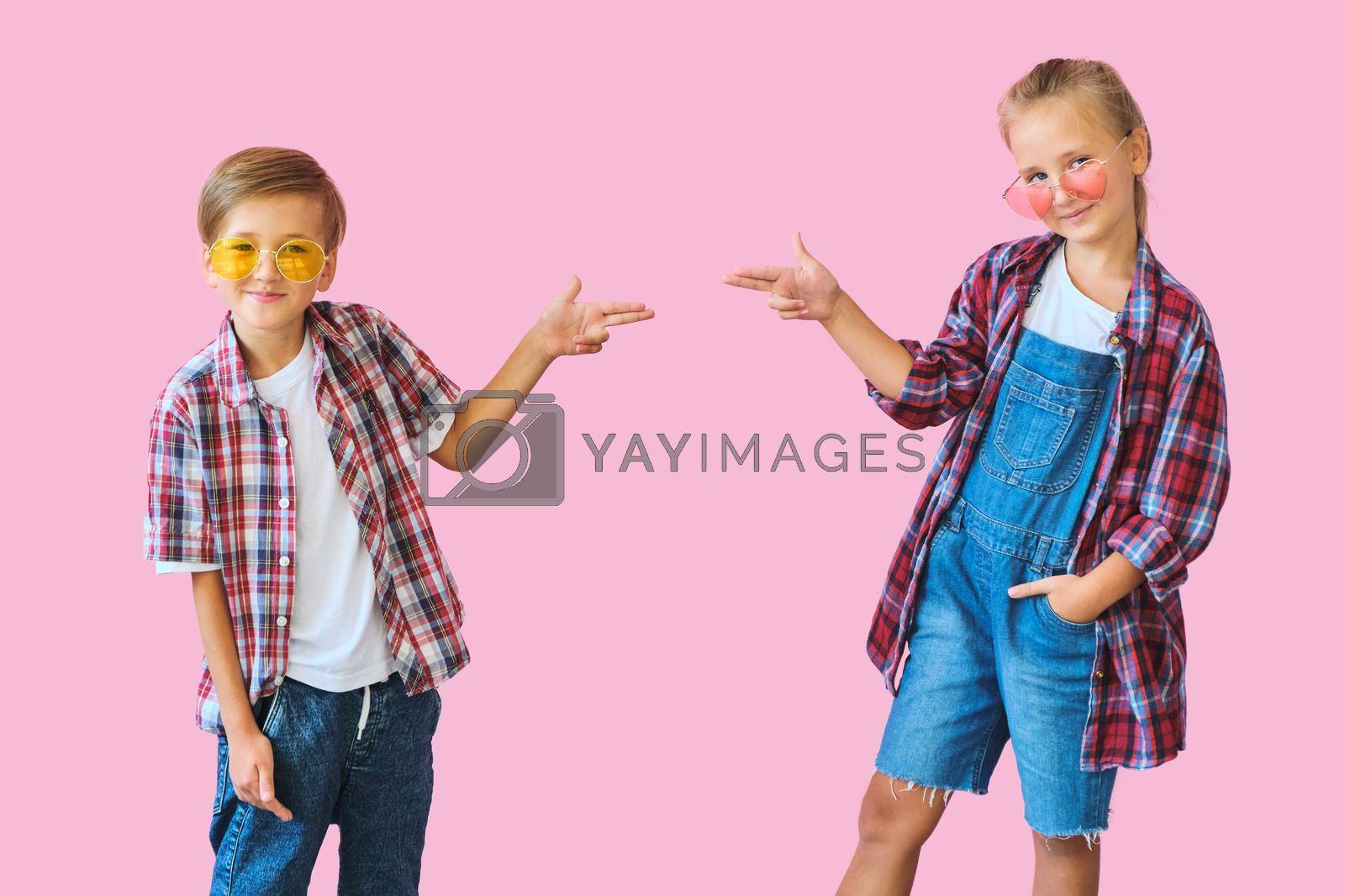 Royalty free image of Cute stylish kids in color sunglasses looking at camera a by InnaVlasova