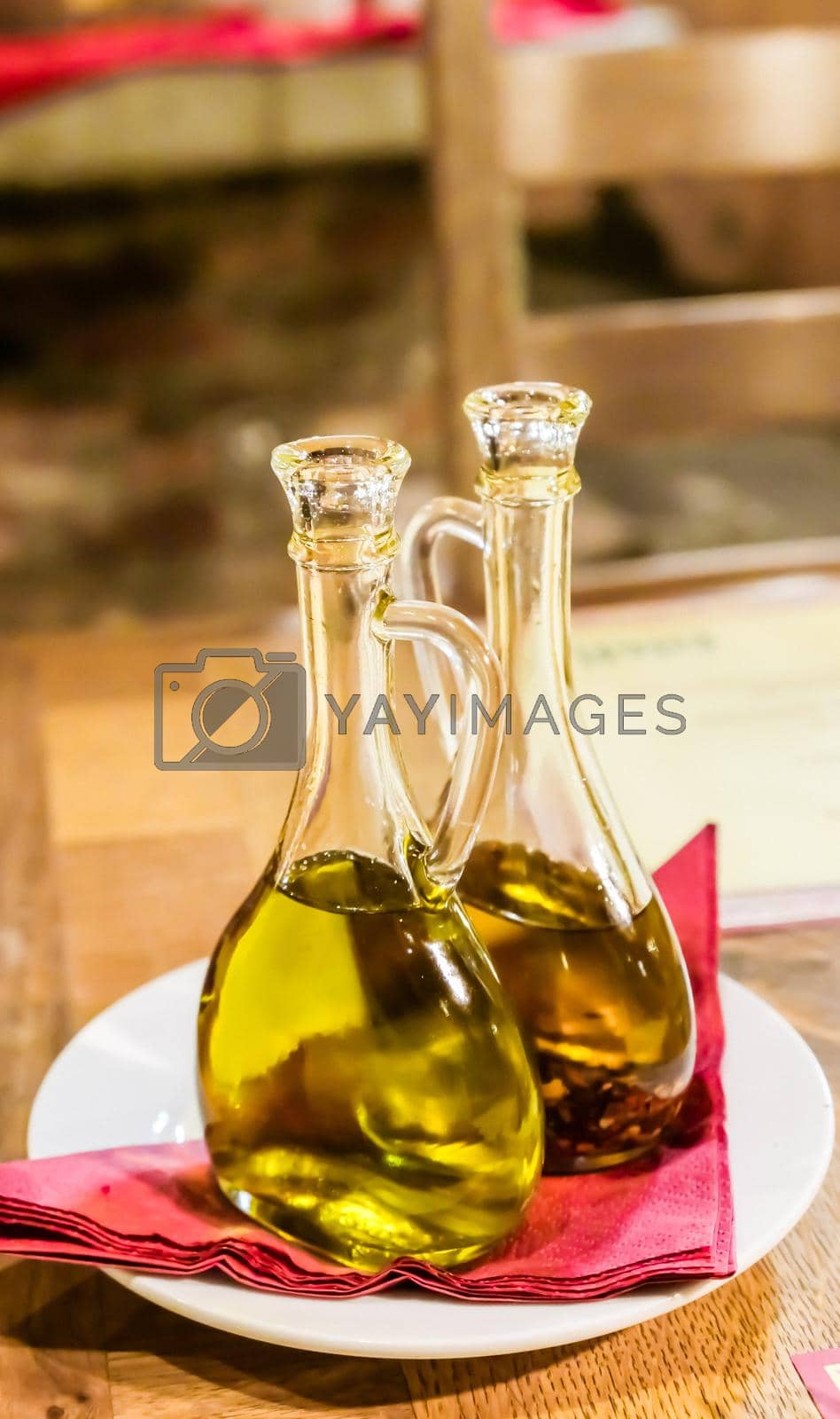 Royalty free image of Bottles of organic extra virgin olive oil in Italian restaurant by Anneleven