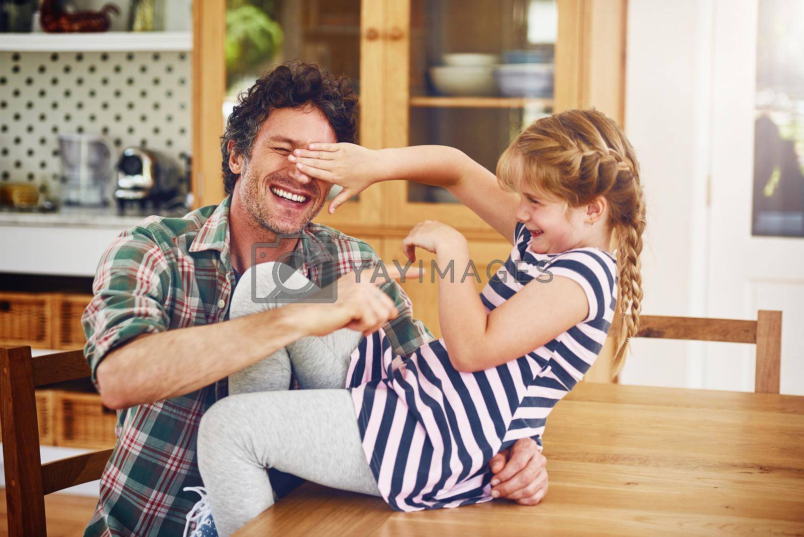 Royalty free image of No day goes by without sharing laughter between them. a father and his little daughter having fun together at home. by YuriArcurs