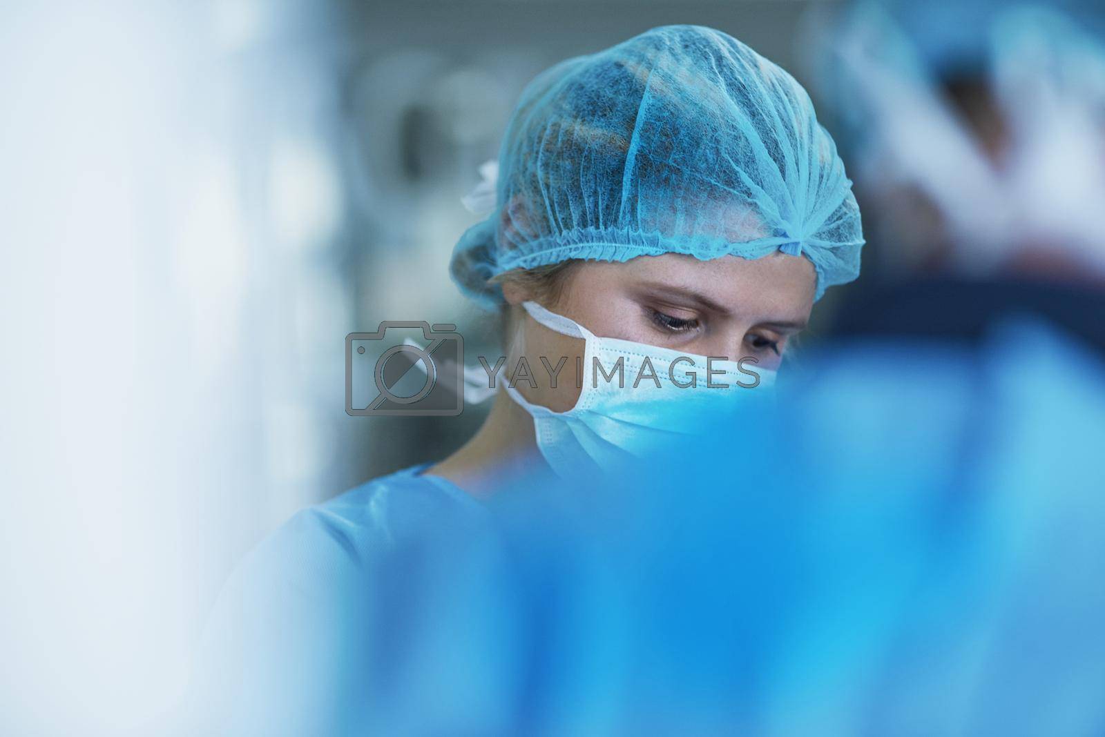 Royalty free image of Highly skilled in surgical procedures. a team of surgeons performing a medical procedure in an operating room. by YuriArcurs