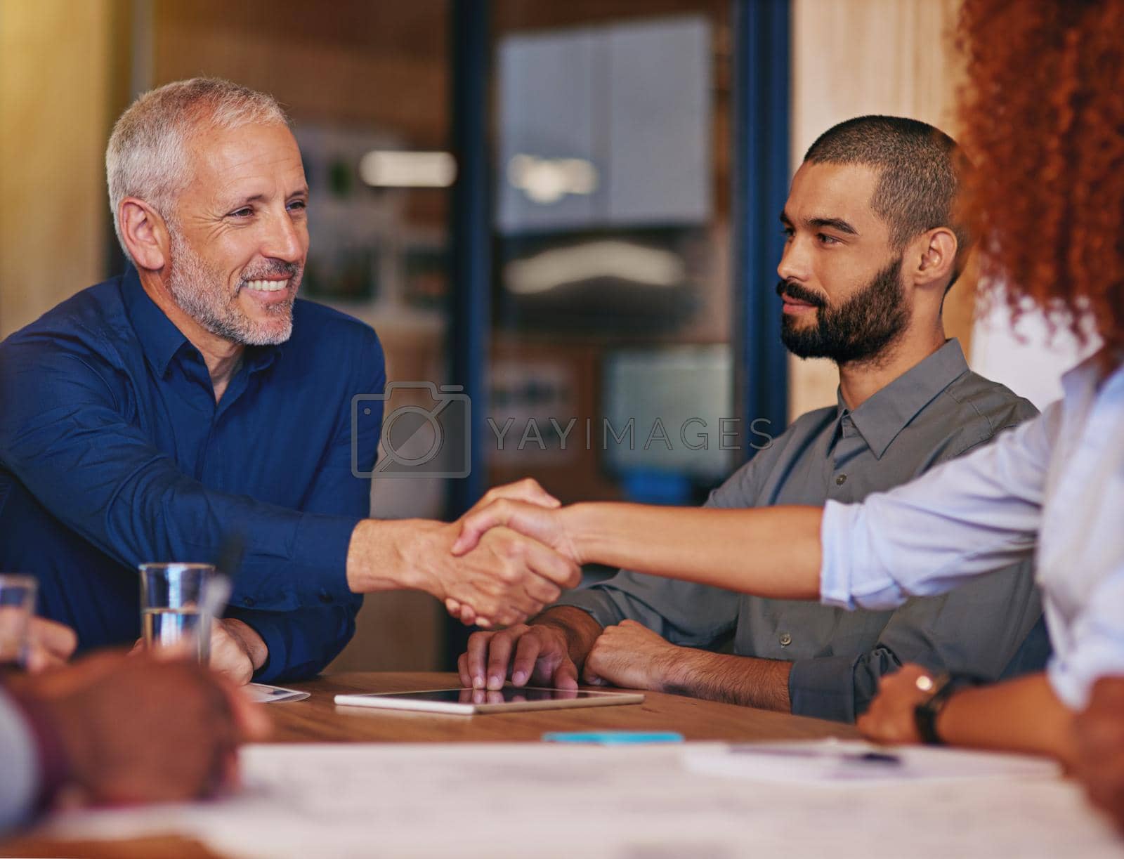 Royalty free image of Welcoming a new member to the team. colleagues shaking hands in an office meeting. by YuriArcurs