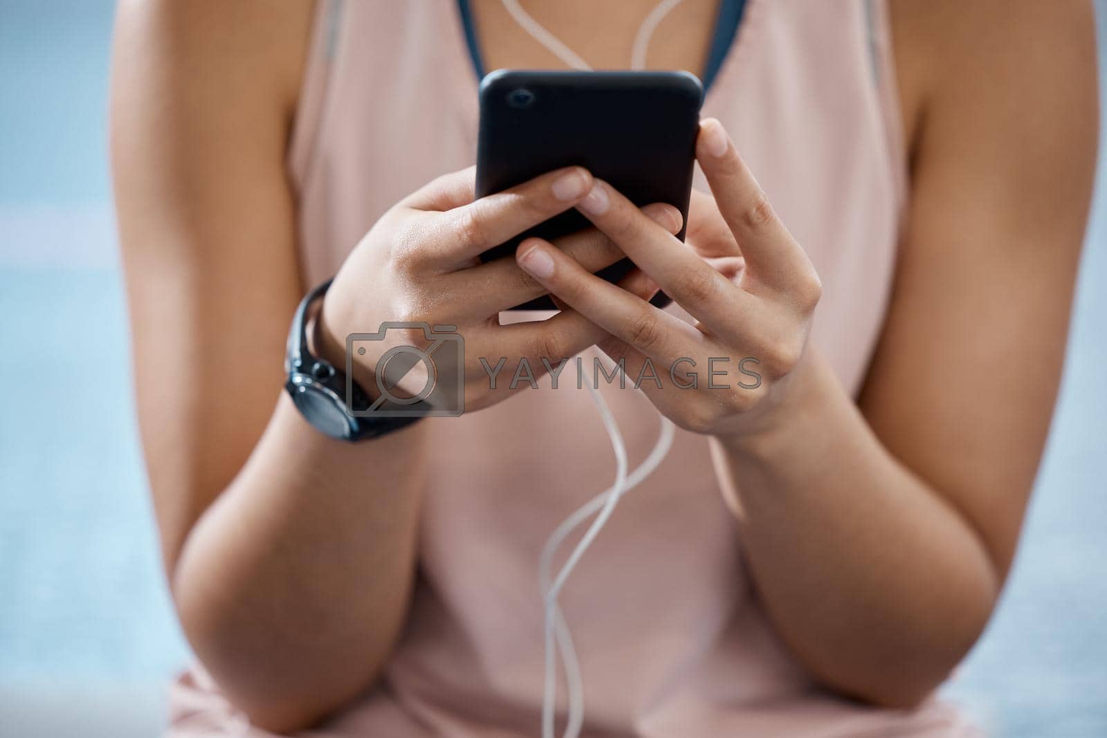 Fitness app, phone and communication while typing on phone in sportswear to track progress on smart device with fast network. Close up hands of a woman listening to music or podcast during training.