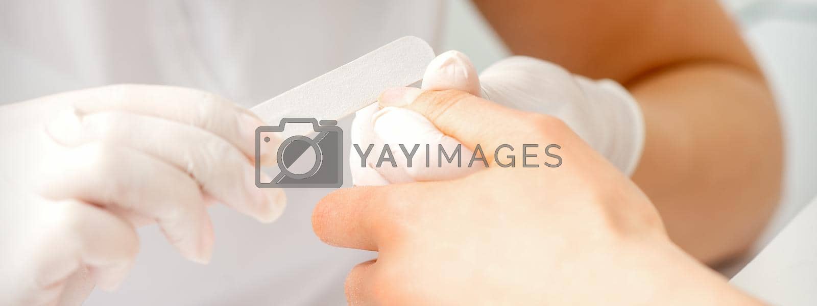 Royalty free image of Hand receiving the nail file by okskukuruza