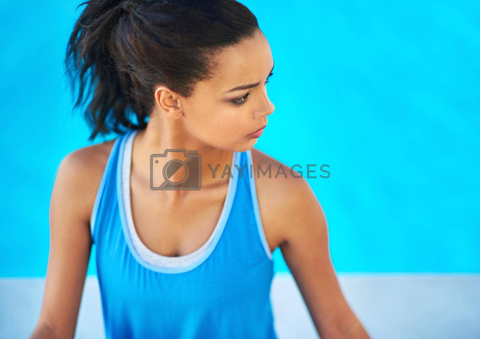 Keep calm and do yoga. a young woman doing yoga outdoors
