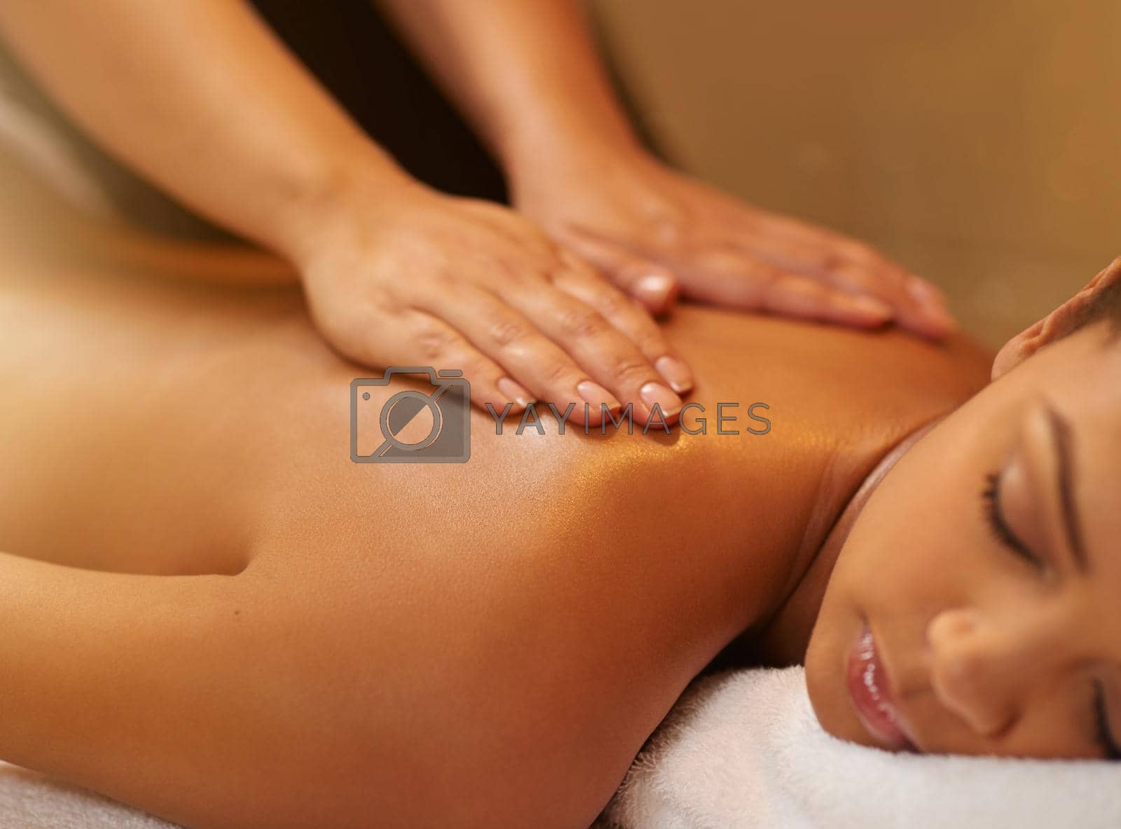 Royalty free image of Let your troubles drift away...a young woman getting a massage at the spa. by YuriArcurs