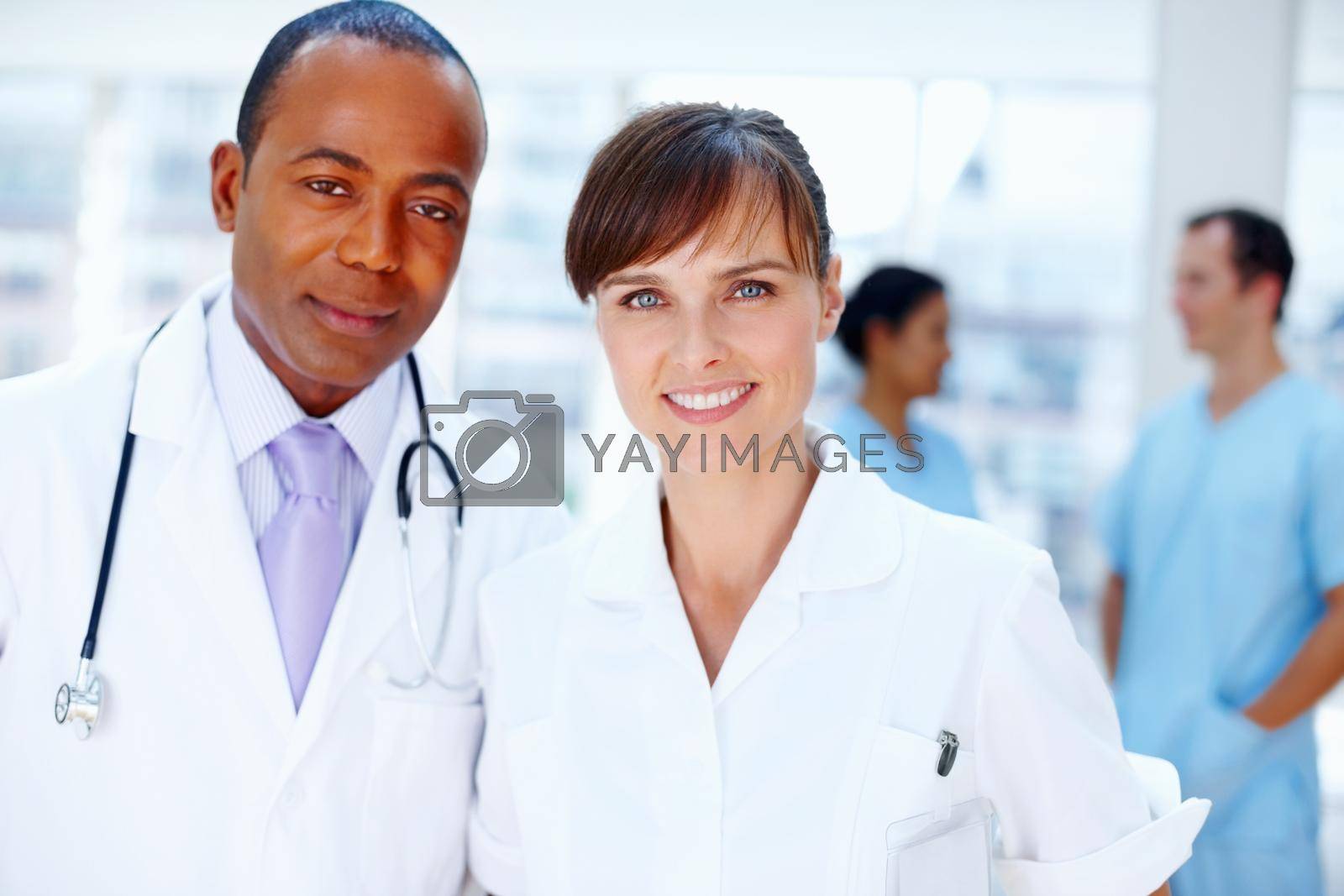 Healthcare professionals. Closeup of doctors with nurses in background