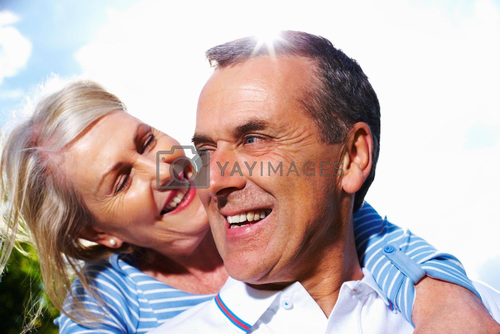 Royalty free image of Smiling senior couple in love against sky. Closeup portrait of a happy senior couple in love against sky. by YuriArcurs